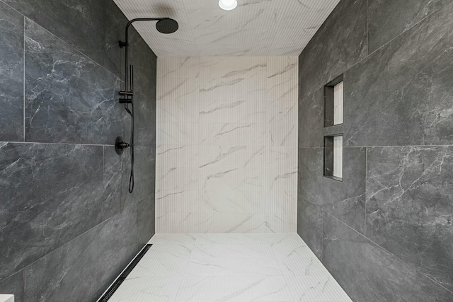 bathroom with a tile shower