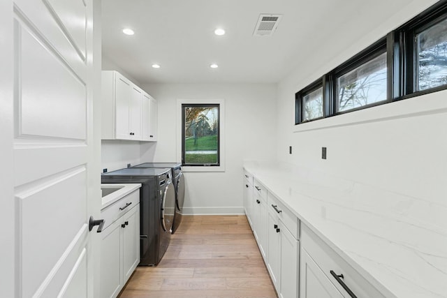 2005 Lakeside Dr, Lexington, KY 40502 - laundry room featuring cabinet space, washer and clothes dryer, light wood-style flooring, recessed lighting, and baseboards