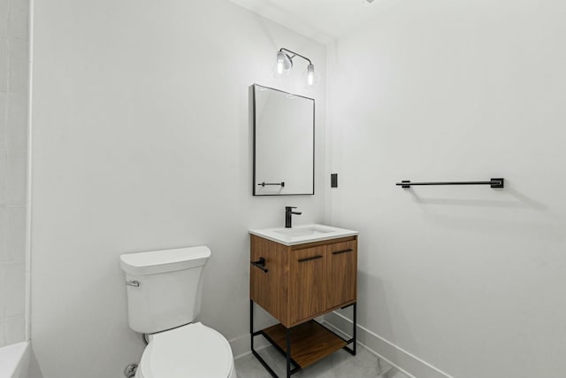 bathroom with baseboards, toilet, and vanity