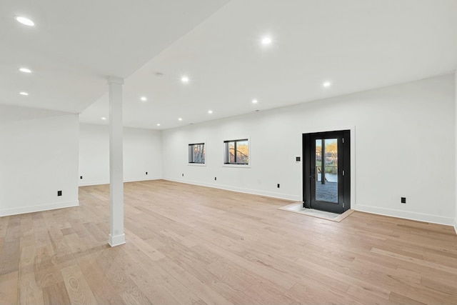 interior space with baseboards, recessed lighting, and light wood-type flooring