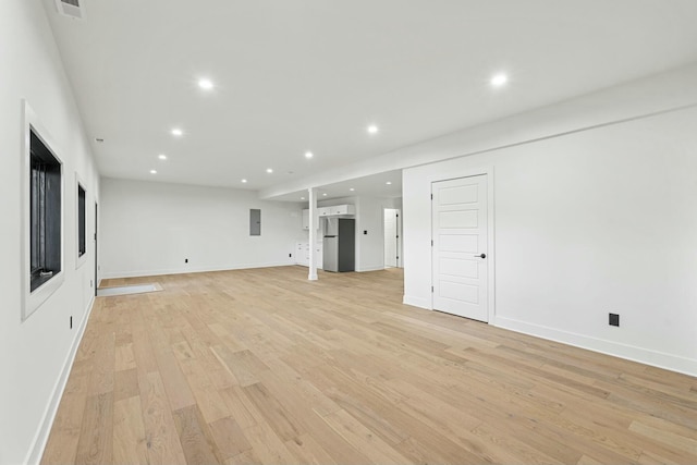 unfurnished living room featuring baseboards, recessed lighting, visible vents, and light wood-type flooring