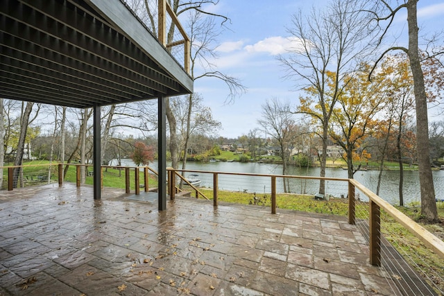 wooden deck with a water view and a patio