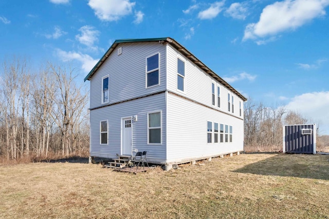 rear view of house featuring a yard