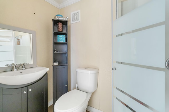 bathroom with vanity, crown molding, and toilet