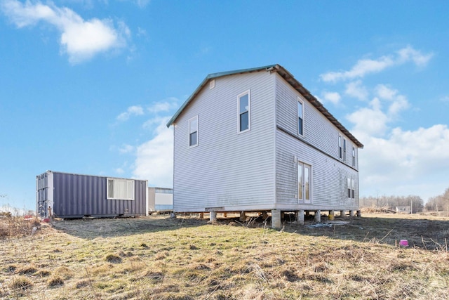 view of side of property with a lawn