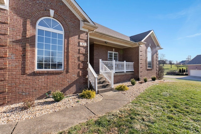 view of front of home with covered porch and a front lawn