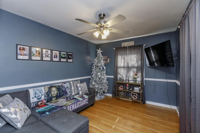 living room with ceiling fan and hardwood / wood-style floors