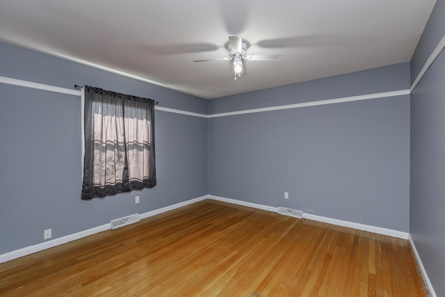 empty room with wood-type flooring and ceiling fan