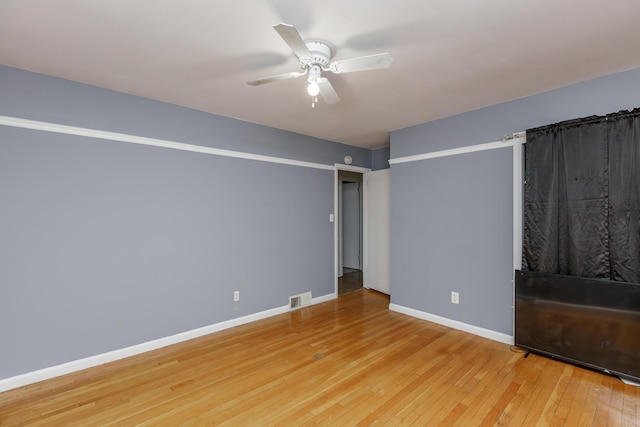 spare room featuring ceiling fan and wood-type flooring