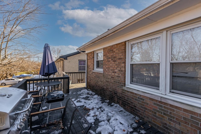 snow covered deck featuring area for grilling