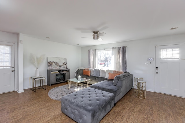 living room with dark hardwood / wood-style floors and ceiling fan