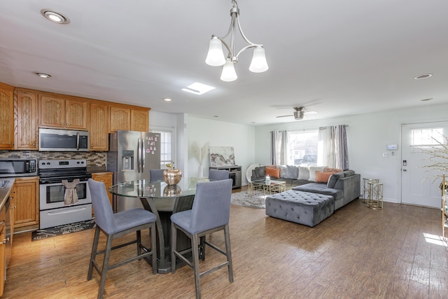 dining space featuring light hardwood / wood-style floors and a chandelier