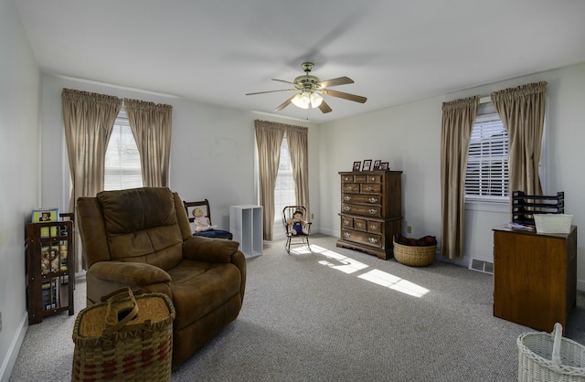 sitting room with light colored carpet and ceiling fan