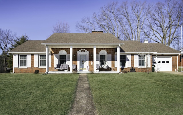 view of front of home with a porch, a garage, and a front yard