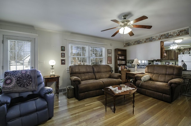 living room with plenty of natural light, hardwood / wood-style floors, and ceiling fan