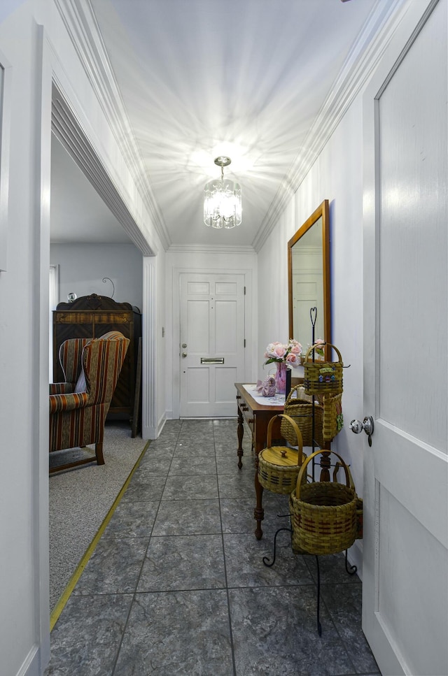 hall with an inviting chandelier and ornamental molding