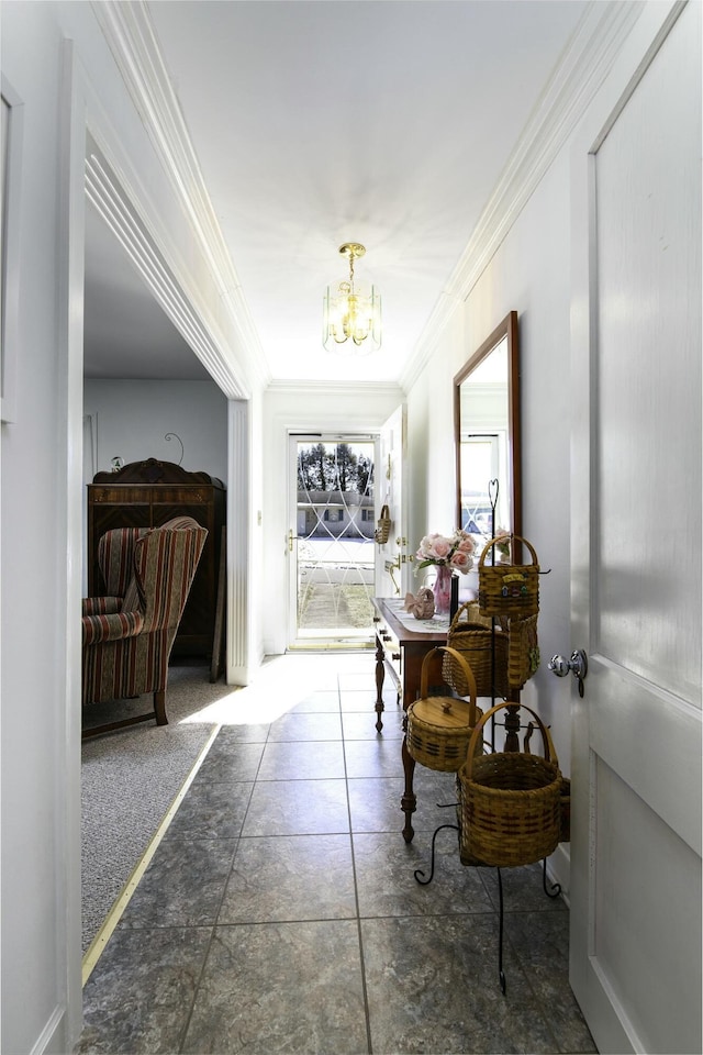 hall featuring crown molding and an inviting chandelier