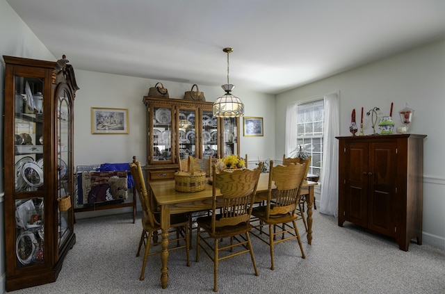 dining area featuring light carpet