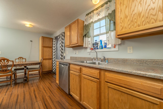 kitchen with sink, dark wood-type flooring, stainless steel dishwasher, and a textured ceiling