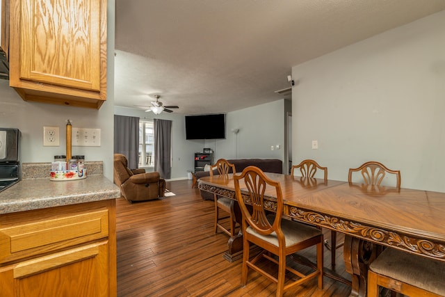 dining room featuring ceiling fan and dark hardwood / wood-style floors