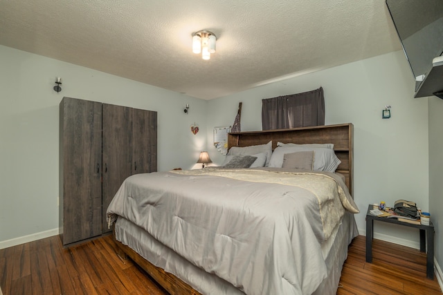 bedroom featuring hardwood / wood-style floors and a textured ceiling