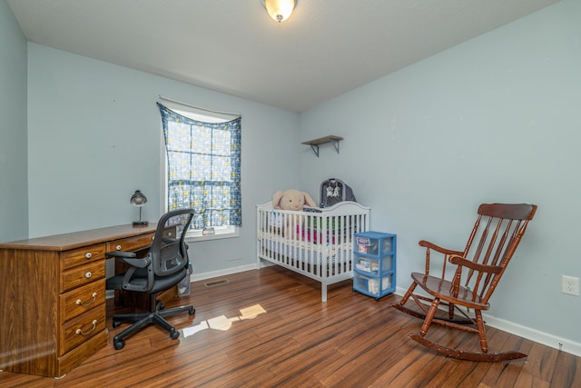 bedroom with dark wood-type flooring