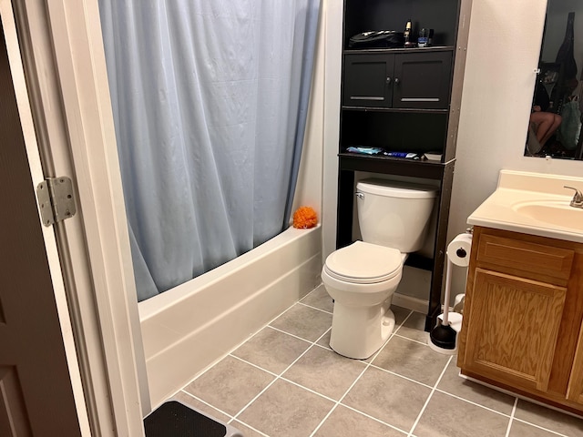 bathroom featuring tile patterned floors, toilet, vanity, and shower / bath combination with curtain