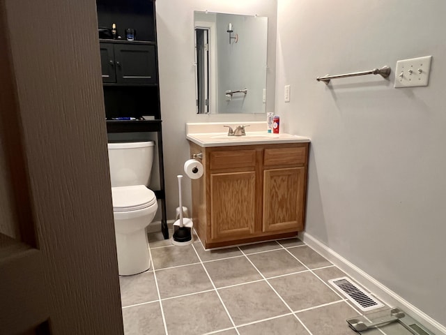 half bath with tile patterned flooring, visible vents, baseboards, toilet, and vanity