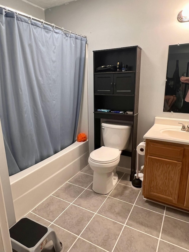 bathroom with tile patterned flooring, toilet, vanity, and shower / bath combo