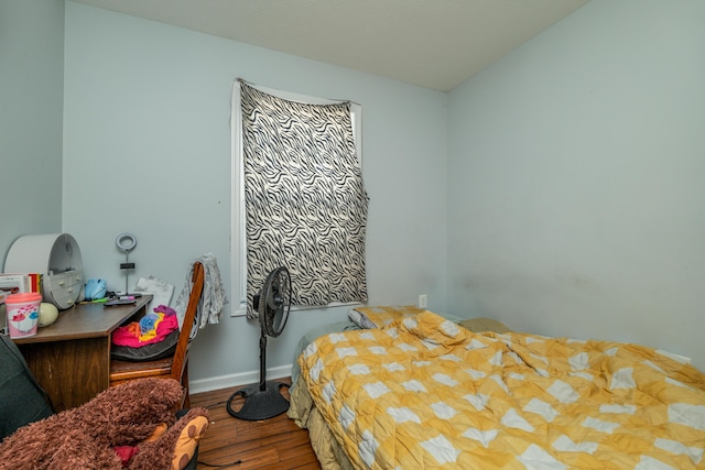 bedroom with wood finished floors and baseboards