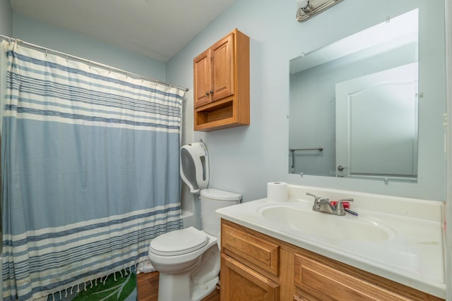 bathroom with a shower with shower curtain, toilet, and vanity