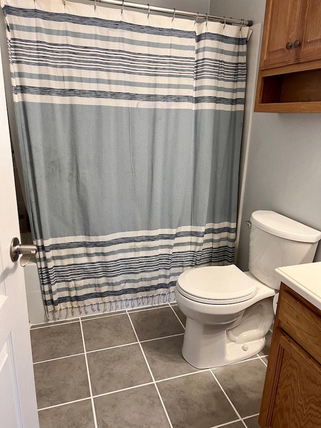 full bath featuring vanity, tile patterned floors, curtained shower, and toilet