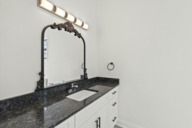 bathroom with baseboards and vanity