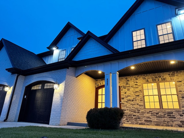 417 Weston Park, Lexington, KY 40515 - view of front of home with board and batten siding, brick siding, and an attached garage