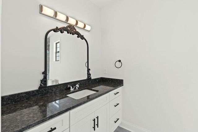 bathroom with vanity and baseboards