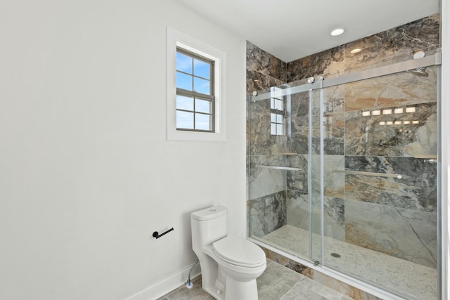 bathroom with baseboards, a shower stall, toilet, and tile patterned floors