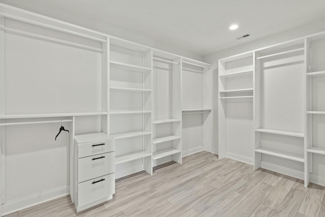 walk in closet featuring light wood-style flooring and visible vents