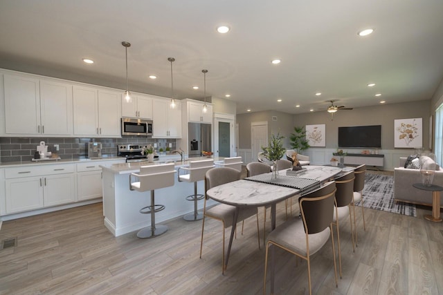 dining room featuring ceiling fan and light hardwood / wood-style floors