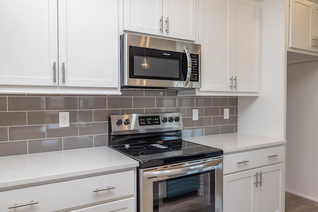 kitchen with decorative backsplash, light stone countertops, white cabinets, and appliances with stainless steel finishes