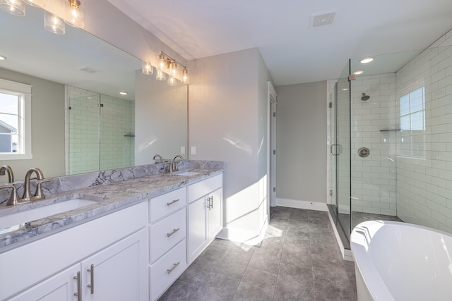 bathroom with vanity and separate shower and tub