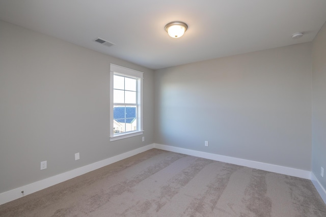 unfurnished room with light carpet