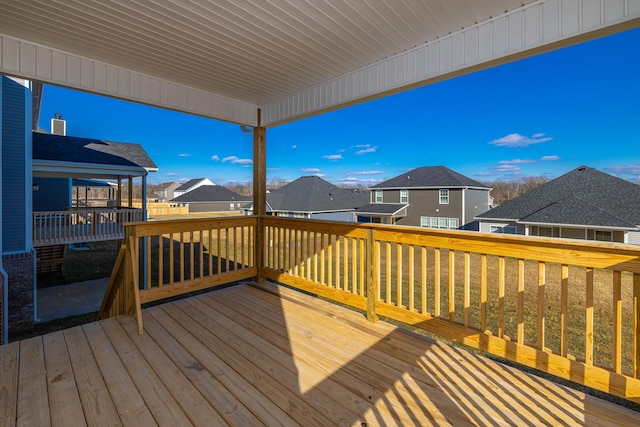 wooden deck with a lawn