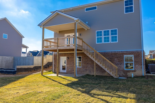 back of house featuring a wooden deck, a yard, a patio area, and central AC unit