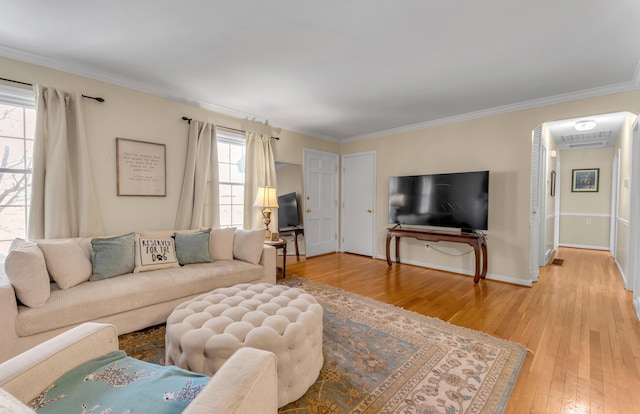 living room with hardwood / wood-style flooring and ornamental molding