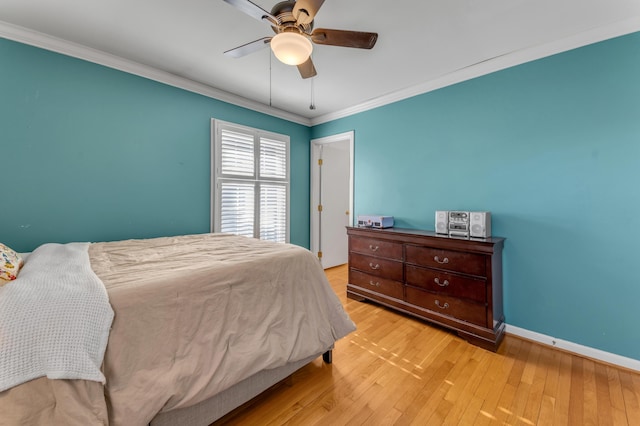 bedroom with crown molding, ceiling fan, and light hardwood / wood-style flooring