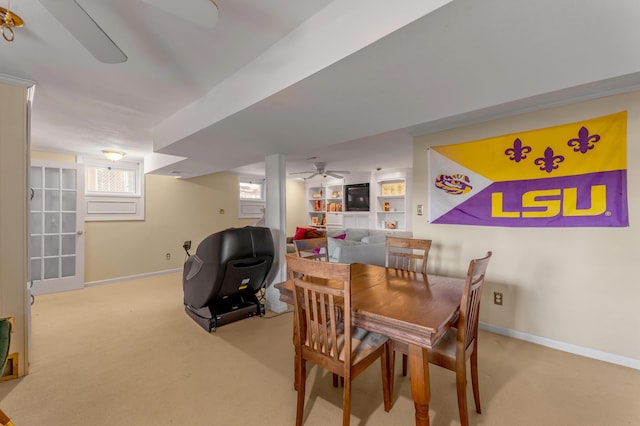 carpeted dining room featuring ceiling fan