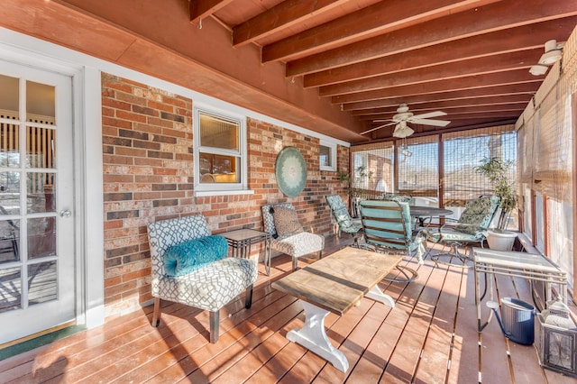 sunroom with beam ceiling and ceiling fan