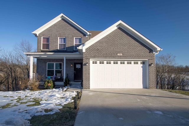 view of property with a garage and covered porch