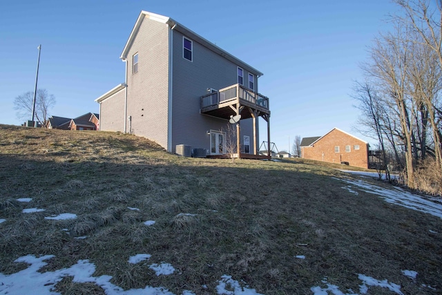 view of home's exterior featuring a balcony, a lawn, and central air condition unit