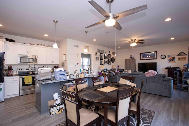 dining space with dark hardwood / wood-style flooring